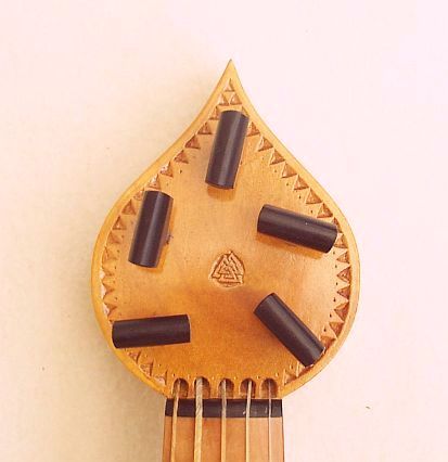 Peg-head with chip-carved border